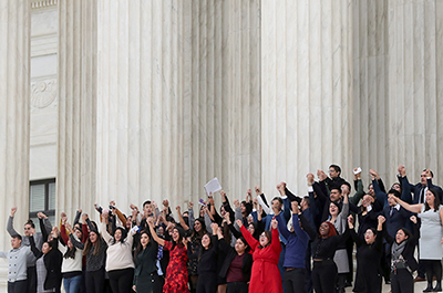 DACA plaintiffs walking arm-in-arm down from the U.S. Supreme Court last November.