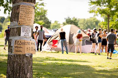 Signs on a tree located near the entrance to the Powderhorn East homeless encampment in south Minneapolis. The encampment was cleared by Minneapolis Police on July 21, 2020.