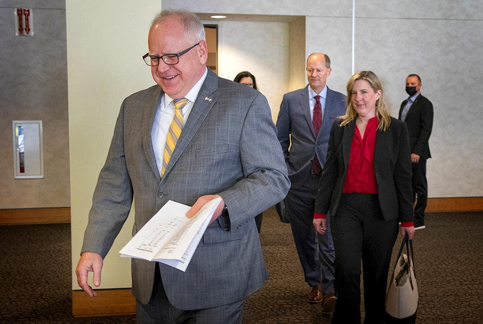 Gov. Tim Walz, with budget agreement in hand, leading Senate Majority Leader Paul Gazelka and House Speaker Melissa Hortman to Monday's news conference.