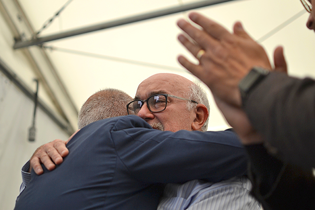 State Sen. David Tomassoni, right, hugging Heliene CEO Martin Pochtaruk during Thursday's ceremonies.