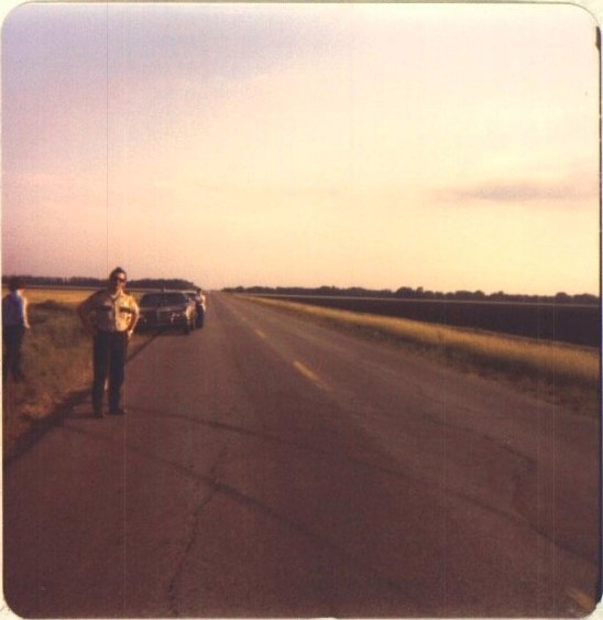 image of sheriffs deputy standing on road