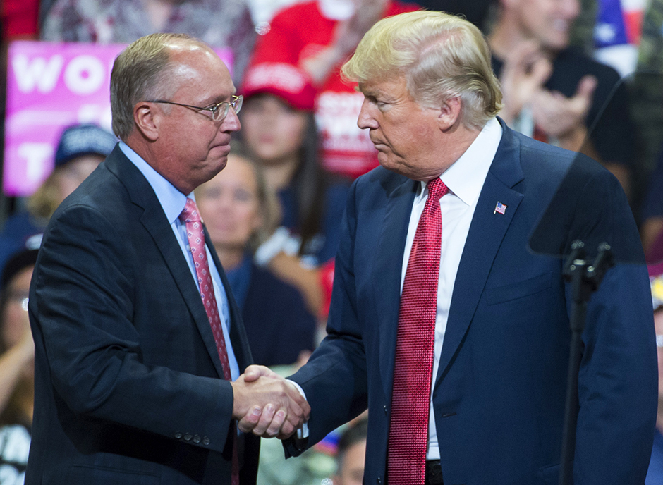 Then-President Trump, right, made a stop in the 1st Congressional District to endorse candidate Jim Hagedorn in October 2018.
