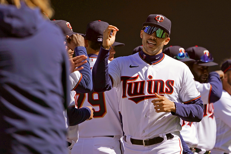 Minnesota Twins shortstop Carlos Correa celebrating with teammates after he is introduced before a game against the Seattle Mariners at Target Field.