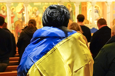 A woman wrapped in a Ukrainian flag