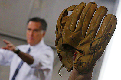 A supporter of Mitt Romney holding up a baseball mitt