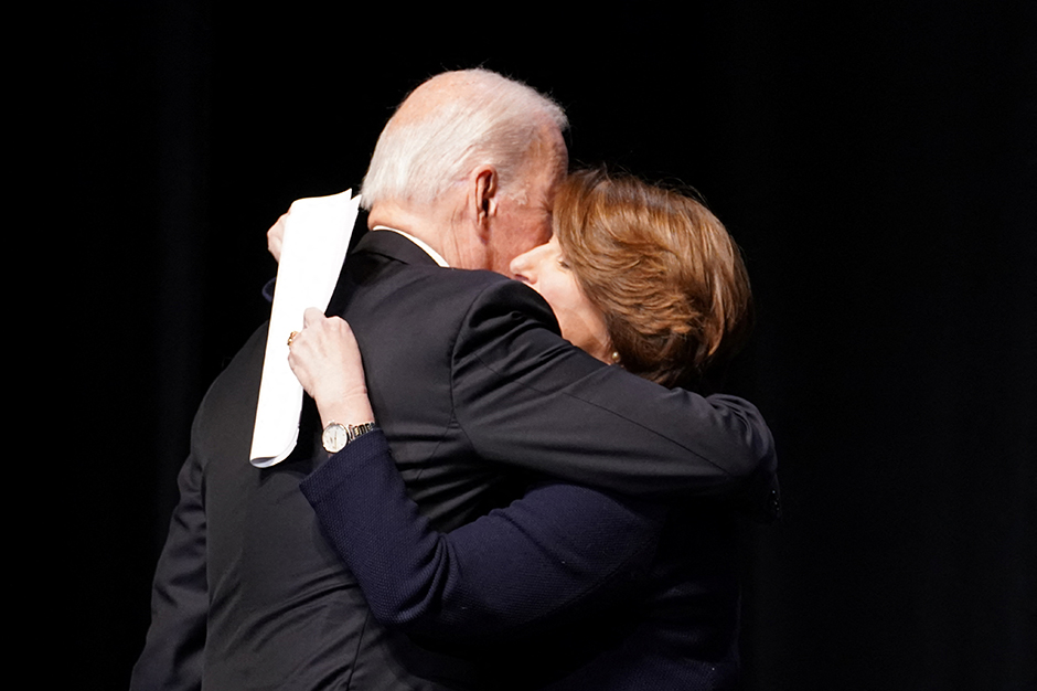 President Joe Biden greeted by Sen. Amy Klobuchar during the memorial service for former Vice President Walter Mondale in Minneapolis on Sunday.