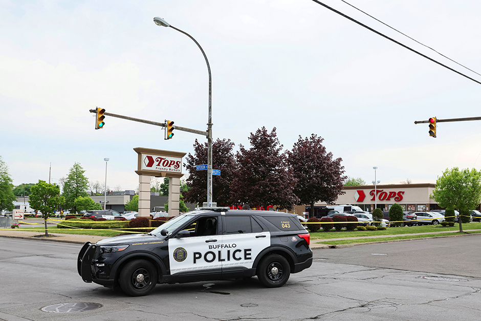 A Buffalo Police car is parked at the scene of a shooting at a Tops supermarket in Buffalo, New York.