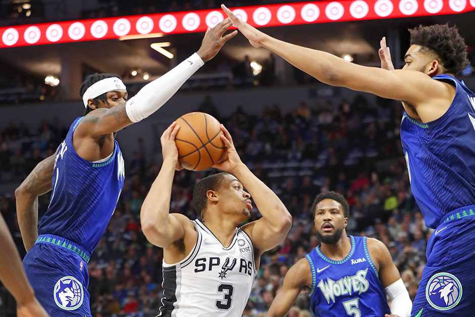 Jarred Vanderbilt, left, and Karl-Anthony Towns, right, defend in the first quarter against the San Antonio Spurs on April 7 at Target Center.
