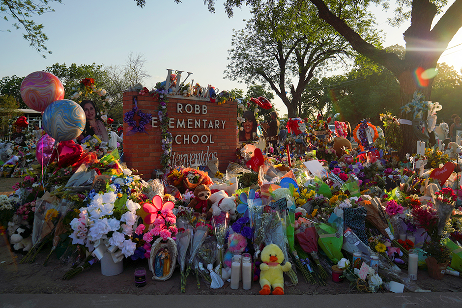 Flowers, toys, and other objects are seen at a memorial at Robb Elementary School in Uvalde, Texas.