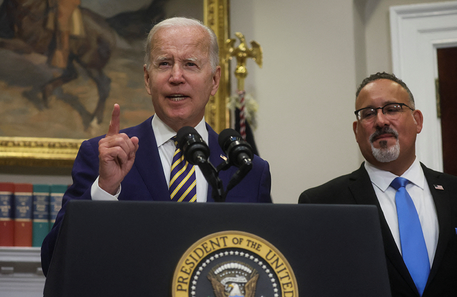 President Joe Biden, flanked by Secretary of Education Miguel Cardona, speaking about administration plans to forgive federal student loan debt in the Roosevelt Room at the White House on Wednesday.