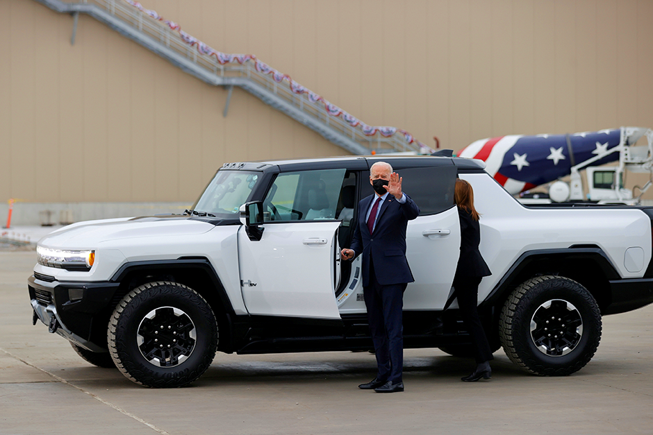 President Joe Biden waving from a Hummer EV while touring the General Motors 'Factory ZERO' electric vehicle assembly plant in Detroit, Michigan.