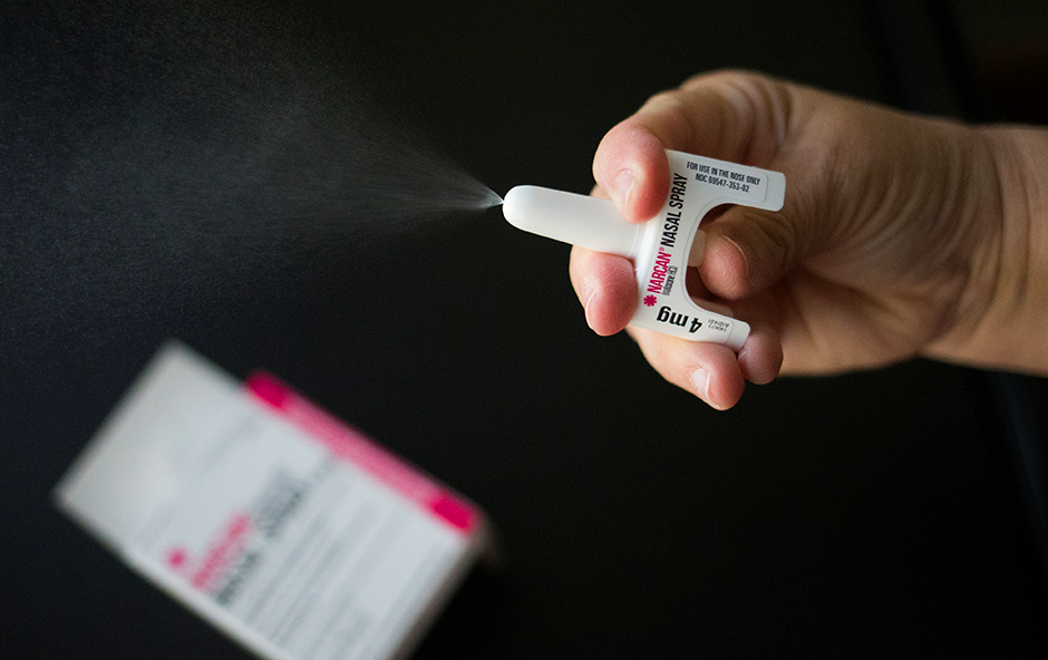 A nurse demonstrating the application of the NARCAN nasal spray medication at a outpatient treatment center.