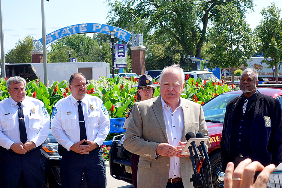 Gov. Tim Walz, center, and Department of Public Safety Commissioner John Harrington, right, et al., discussed safety at the Minnesota State Fair on Tuesday.