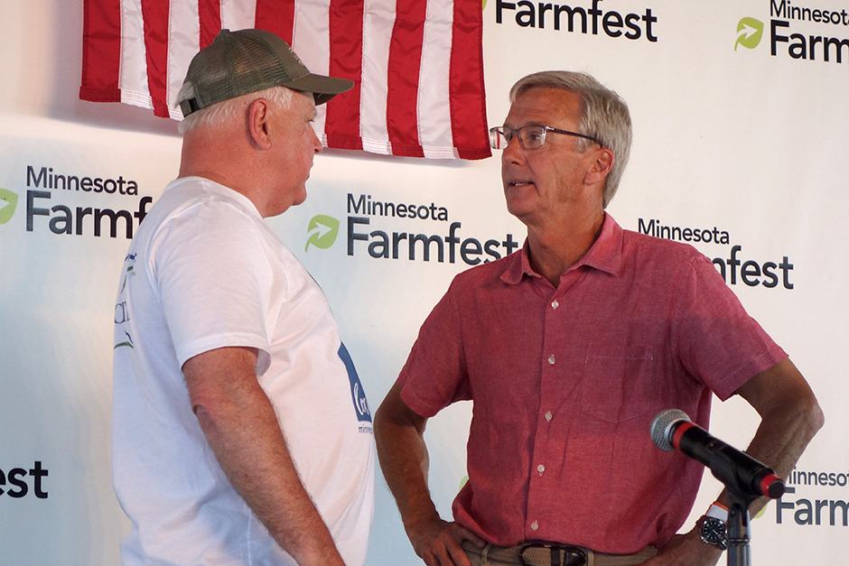 Gov. Tim Walz and Scott Jensen chatting following their debate at Farmfest in August.