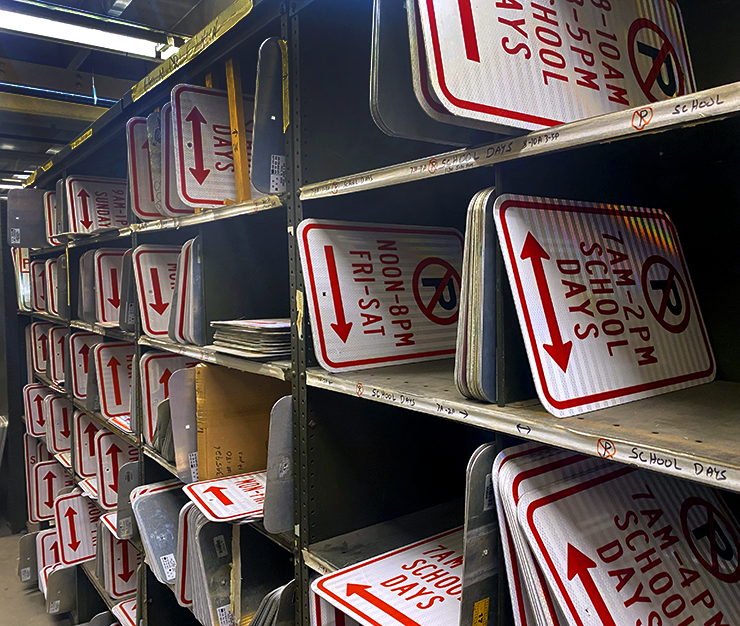 When you glance at the rows of shelves at the sign shop, containing all 4,000 unique designs used by the city, you realize that most of them are about parking.
