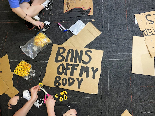 Students made signs by hand before they marched across campus in protest of South Dakota’s abortion ban. They are advocating for access to safe abortion care and trying to figure out how to help people who may become pregnant and need abortions in the meantime