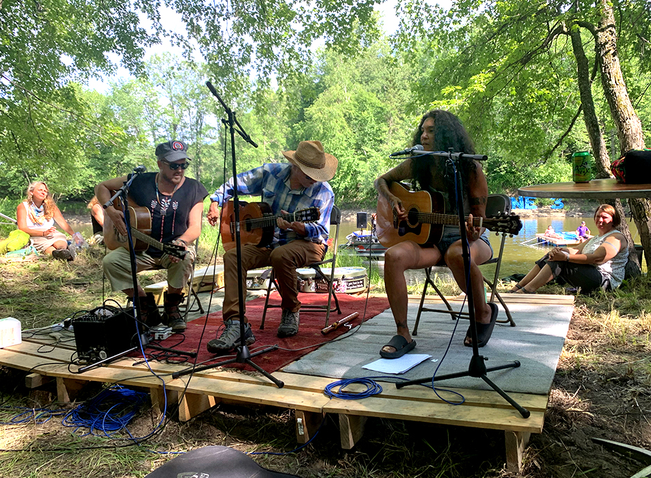 David Huckfelt, Keith Secola and Annie Humphrey performing at the Protect The Water/Stop Line 3 event in Aitkin County in 2021.
