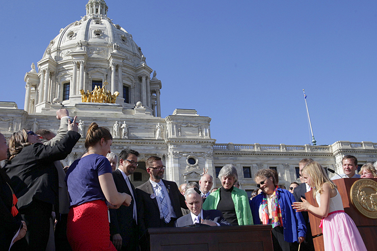 Gov. Mark Dayton signing the bill legalizing same-sex marriage in Minnesota.
