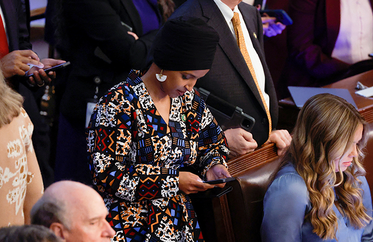 Rep. Ilhan Omar checking her mobile phone on the floor of the House of Representatives as House Republican leader Kevin McCarthy is defeated in the first round of voting on Tuesday.