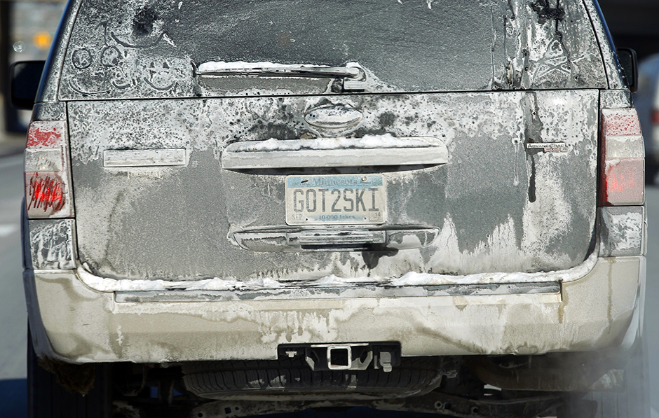 The back of a vehicle covered in road salt.