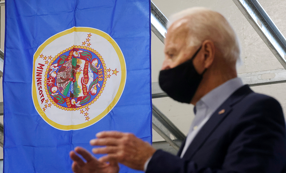 Then presidential candidate Joe Biden is shown speaking with union carpenters in front of Minnesota state flag during a 2020 campaign event in Hermantown.