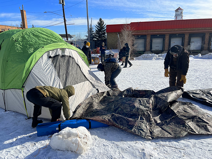 Protestors setting up tents during an occupation of the former Roof Depot warehouse property on Tuesday, Feb. 21.