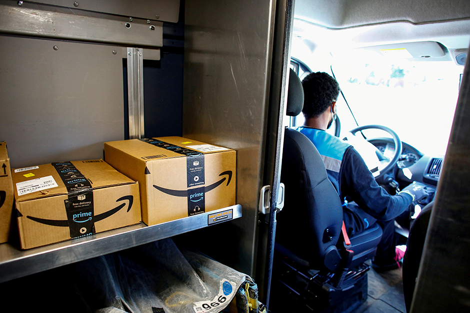 An Amazon worker delivering packages