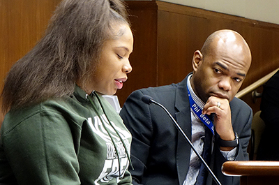 Jamiccia Donnerson testifying before the House Public Safety Committee last week. At right is bill sponsor Rep. Cedrick Frazier.