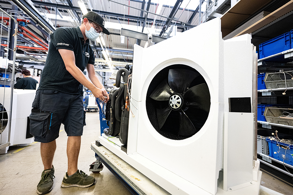 A worker assembling a heat pump at the Stiebel Eltron plant in Holzminden, Germany.