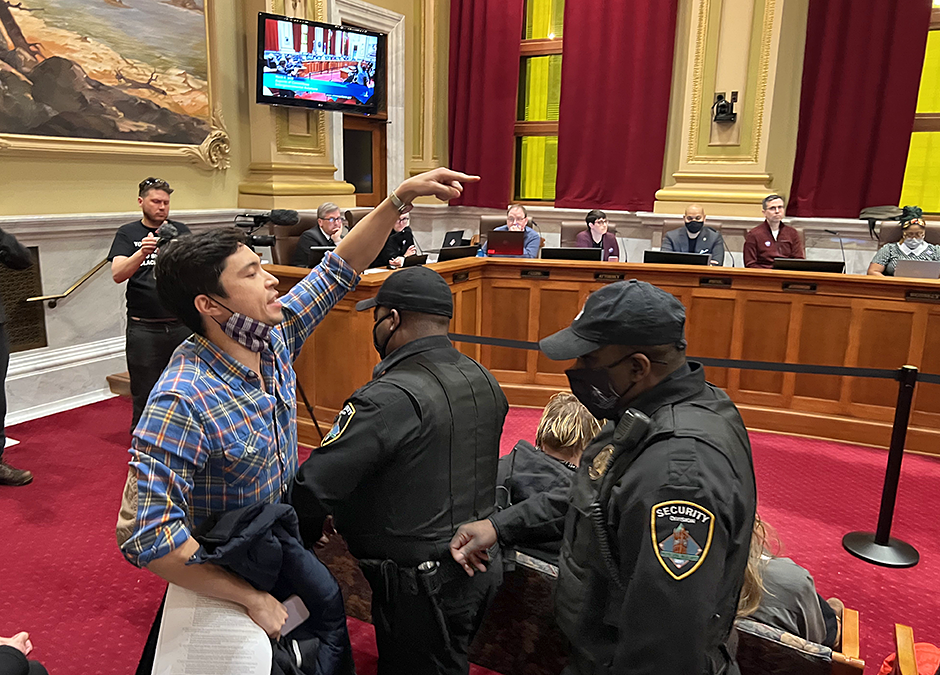 Security officers removing an audience member from the Minneapolis City Council meeting on Thursday, March 9. “I'll subtweet your ass!” the protestor shouted at council member Michael Rainville as he left the room.