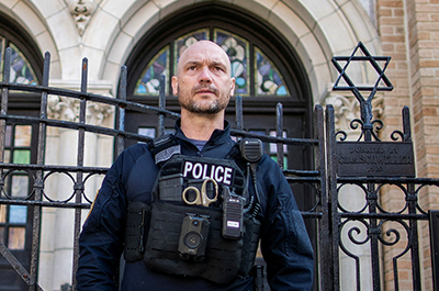 A New Jersey police officer standing guard in front of the United Synagogue of Hoboken in New Jersey, on November 4, 2022.