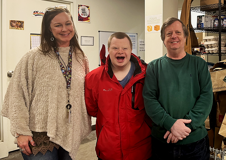 Michelle Ness, left, is PRISM'S executive director. Timothy Reckinger and Keith Olson are volunteers at the food shelf. They come in twice a week and help bag items into grocery bags. They’ve been helping at PRISM since 2015.