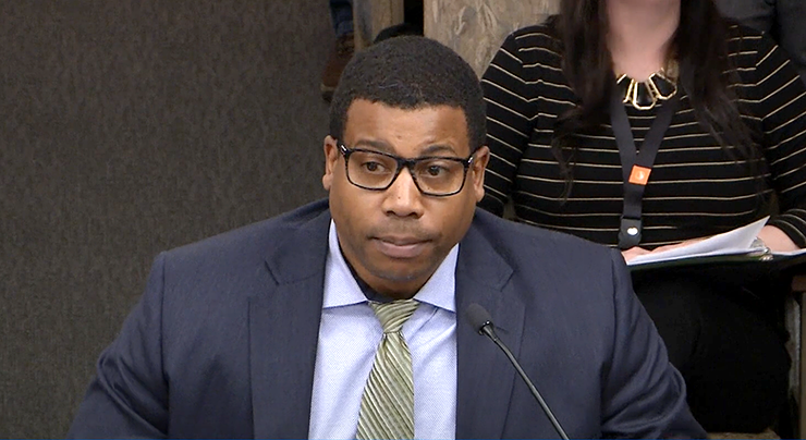 Ryan Hamilton, government relations associate for the Minnesota Catholic Conference, shown speaking against the marijuana bill during a House Commerce Finance and Policy Committee meeting on January 11.
