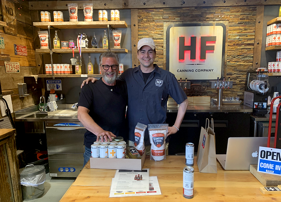 Jeff Cerise and his son, Franco, at the Hobby Farmer Canning Company booth at Keg & Case Market in St. Paul.