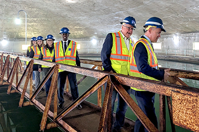 Gov. Tim Walz, Lt. Gov. Peggy Flanagan, Mayor Melvin Carter, and others, shown touring a water treatment plant in St. Paul in January.