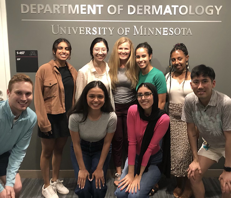 Boraan Abdulkarim, front row in pink, and other students in the dermatology interest group at the University of Minnesota.