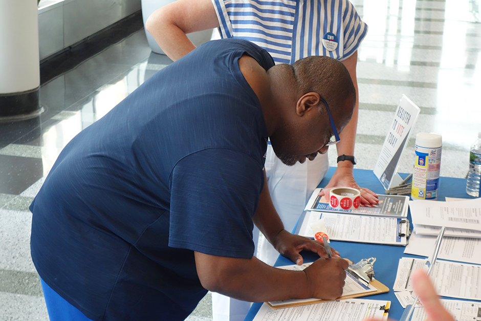 Milton Rucker shown registering to vote at a recent League of Women Voters registration event.