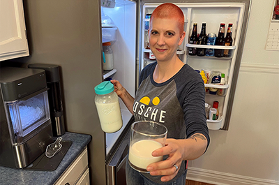 Iowa farmer Stacy Wistock offers a sample of chilled, unpasteurized goat milk.