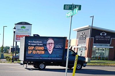 A mobile billboard announcing “GOP: Stand up to Putin,” in Otsego