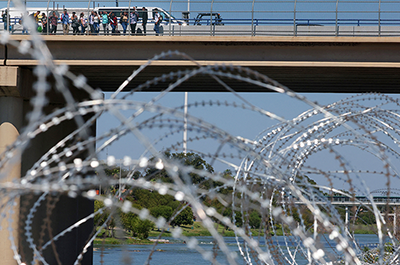Migrants crossing the Eagle Pass International Bridge from Mexico to the United States.