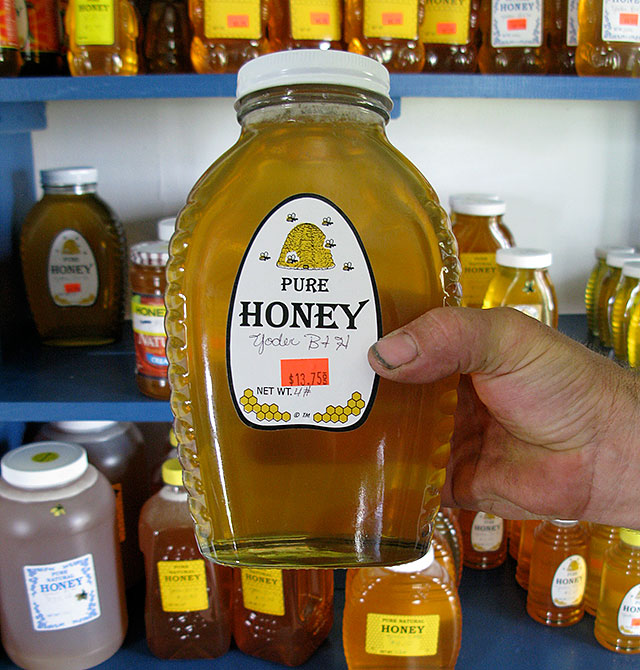 Eli Yoder holds up an example of his best-selling honey product