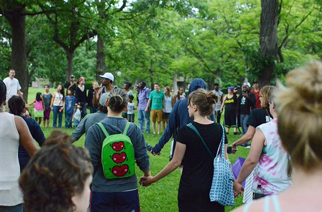 Protesters join hands at Loring Park in a moment of silence