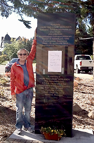 Robert Moilanen next to the Big Louie Moilanen monument.