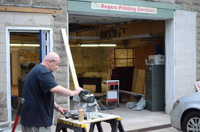 East St. Paul resident Travis Decory cuts wood trim on a circular saw