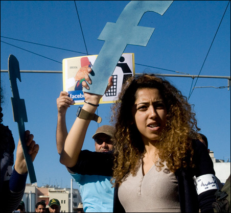 A protester in Rabat, Morocco, holds a "f" in recognition Facebook's role in the North African revolts, during a protest in March.