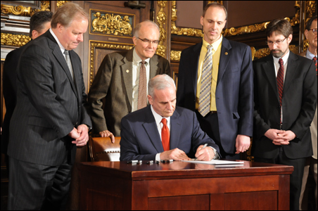 At a bipartisan ceremony, Gov. Mark Dayton signs the agriculture bill.