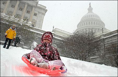 Sledders play in the snow on the West Front of the U.S. Capitol in Washington on Saturday.