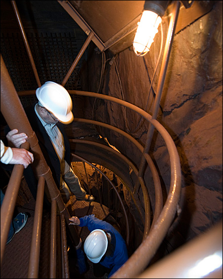 Workers take steps down the shaft leading to the underground laboratory.