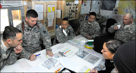 Maj. Shawne Menke briefs the crews on the risks they face going into in Sadr City, Baghdad.