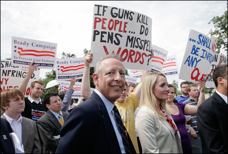 Plaintiff Dick Heller makes his way through a sea of signs Thursday outside the U.S. Supreme Court.